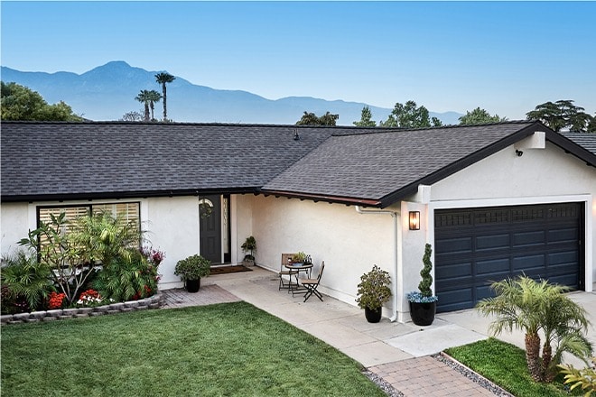 White home with Timberline HDZ RS roof shingles in Charcoal
