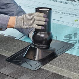 GAF contractor sliding the Master Flow Pivot roof pipe boot over plumbing pipe.