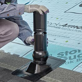 GAF contractor aligning Master Flow Pivot pipe flashing insert with plumping pipe opening.