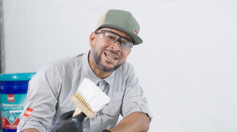 Video playlist thumbnail of a contractor holding a brush treating roofing seams with GAF Silicone Mastic